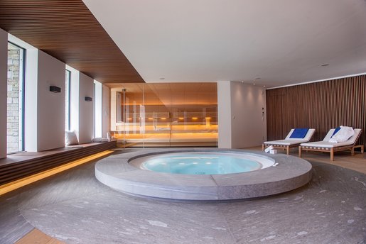 Le jacuzzi de trois mètres de diamètre en quartzite de Vals de haute qualité se trouve au centre de cet oasis de bien-être.